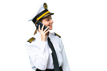 Airplane pilot woman over isolated chroma key background keeping a conversation with the mobile phone with someone © luismolinero