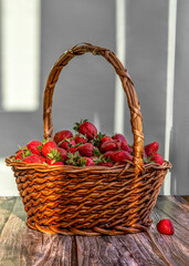 Fototapeta na wymiar A basket with strawberries close-up on the table.