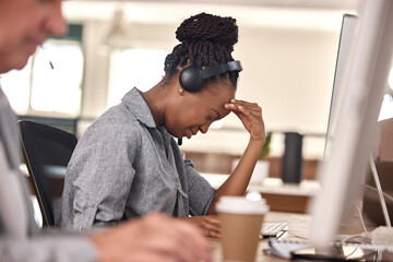 Call center, woman and stress or headache at computer in office and tired of sales or customer service. African female agent or consultant in telemarketing, support and crm with mental health burnout