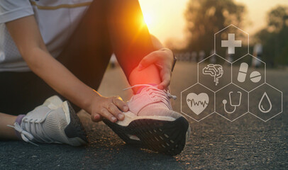 Ankle twist sprain accident in sport exercise running jogging.low key lighting.