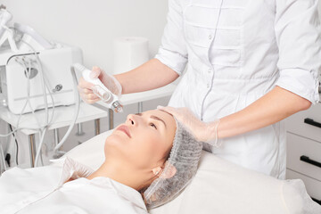 Cosmetologist makes facial gas liquid oxygen serum epidermal peeling for rejuvenation woman face...
