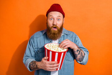 Photo of young funny excited emotion surprised eating popcorn watching comedy good mood vacation...