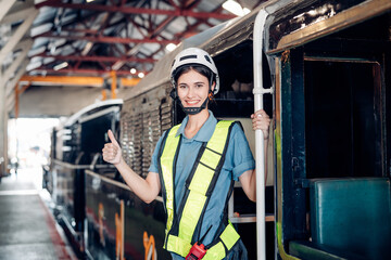 Portrait of woman engineer standing  and looking camera in train factory. Maintenance cycle concept.
