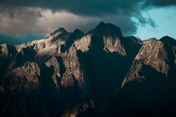 Beautiful shot of mountains with partial sunlight on a cloudy day - great for background