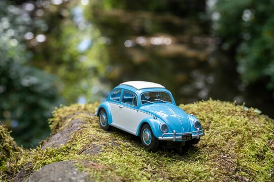 VW Beetle model car, in a nature scene, on a mossy stone