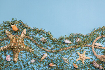 Blue nautical background with sea shells, starfishes and fishing net. Assorted marine animals