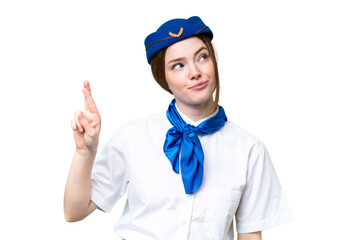 Airplane stewardess over isolated chroma key background with fingers crossing and wishing the best