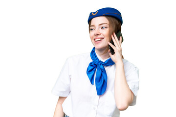 Airplane stewardess over isolated chroma key background keeping a conversation with the mobile phone