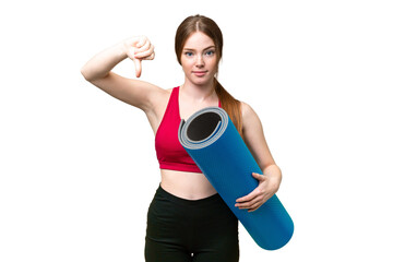 Young sport woman going to yoga classes while holding a mat over isolated chroma key background...