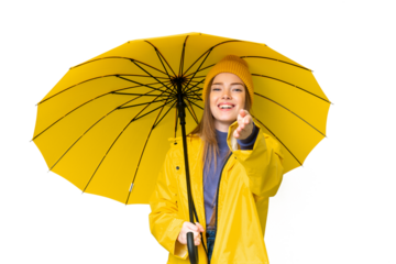 Young pretty woman with rainproof coat and umbrella over isolated chroma key background shaking hands for closing a good deal