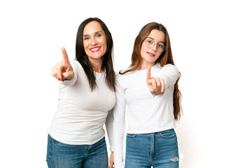 mother and daughter over isolated chroma key background showing and lifting a finger