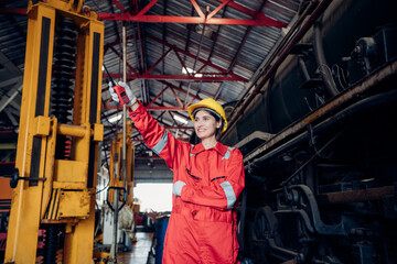 Fototapeta na wymiar Portrait of female engineer working and looking camera in industrial factory. Women in industry concept. 