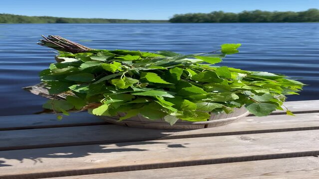 Closeup of a Traditional sauna birch bundle by a lakeside