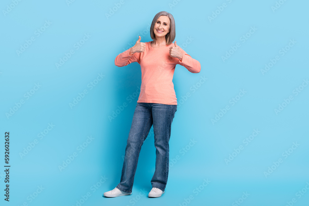 Sticker Full length photo of satisfied good mood person wear pink shirt showing thumbs up approval nice work isolated on blue color background