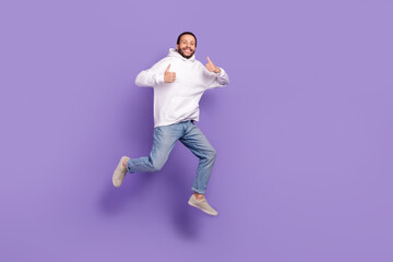 Fototapeta na wymiar Full length photo of youngster funny handsome man wear jeans hoodie thumbs up rate product placement isolated on violet color background