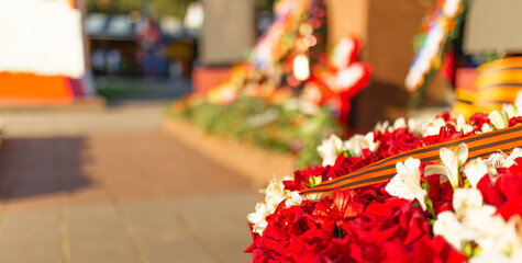 Victory Day, 9 May holiday concept. ribbon of St.George and flowers, natural spring background. traditional symbol of Victory Day 1945. memory of war 1941-1945