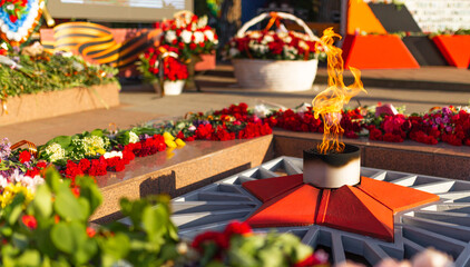 Victory Day, 9 May holiday concept. ribbon of St.George and flowers, natural spring background. traditional symbol of Victory Day 1945. memory of war 1941-1945