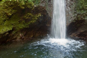 Fototapeta na wymiar Mesmerizing Madeira Waterfalls with water flowing through rocky cliffs into a pool