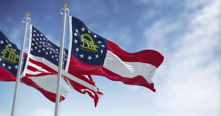 Seamless loop in slow motion of Georgia and US waving on a clear day