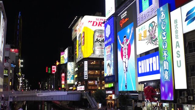 OSAKA, JAPAN : Time lapse shot of Dotonbori area, sunset to night. Tourist destinations, filled with neon signs, clubs and restaurants. All the logo and signs are blurred or overwritten for this video