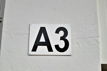 Closeup shot of the entrance gate sign and number A3 of the stadion's white wall © Esa Hiltula/Wirestock Creators
