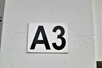 Closeup shot of the entrance gate sign and number A3 of the stadion's white wall