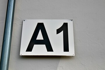 Closeup shot of the entrance gate sign and number A1 of the stadion's white wall © Esa Hiltula/Wirestock Creators