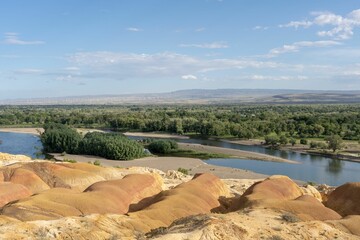 Scenic shot of the colorful and rocky beach of Xinjiang in China under the blue sky in summer