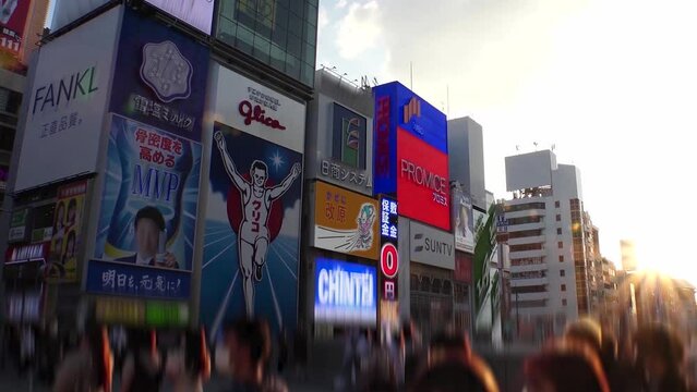 OSAKA, JAPAN : View of Dotonbori area. Tourist destinations, filled with neon signs, clubs and restaurants. Time lapse shot, sunset to night. Logo and signs are blurred or overwritten for this video.