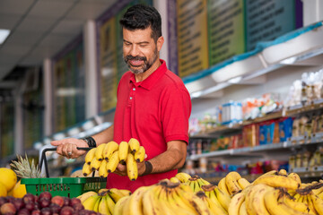Consumer chooses fruit in supermarket.