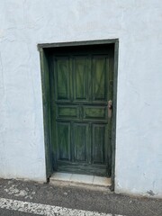 Old green door of a white rural house