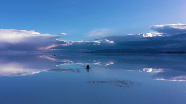 Uyuni Salt Flats. Salar De Uyuni. Aerial View. Altiplano, Bolivia. Rainy Season. SUV Cars. Clouds Reflection on Water in Lake Surface. Orbiting