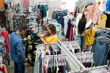 Customer chooses products in clothing store.