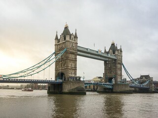 Fototapeta na wymiar Scenic view of a tower bridge on a gray sky background