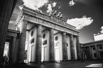 Grayscale shot of the Brandenburg Gate Monument in Berlin with a cloudy sky