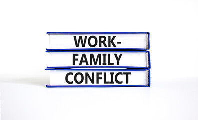 Work-family conflict symbol. Concept words Work-family conflict on books on a beautiful white table white background. Business work-family conflict concept. Copy space.