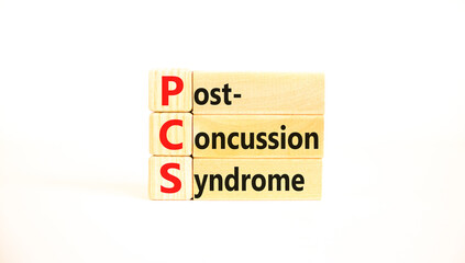 PCS post-concussion syndrome symbol. Concept words PCS post-concussion syndrome on wooden blocks on a beautiful white table white background. Medical PCS post-concussion syndrome concept. Copy space.