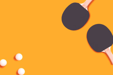 Tennis rackets and white balls on a yellow background. Ping pong concept with place for your design.