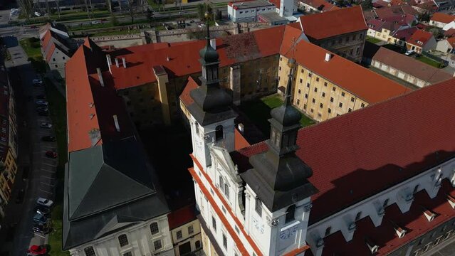 Massive cathedral with orange roofing in Trnava, Slovakia, architecture, 4k