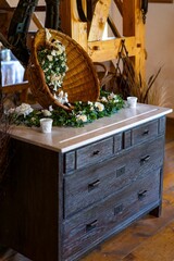 Vertical shot of a floral decoration on a wooden cabinet