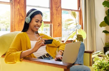 Foto op Plexiglas Muziekwinkel Happy woman, laptop and credit card with ecommerce and headphones to listen to music while online shopping. Female relax at home, radio streaming with fintech, internet banking and payment success