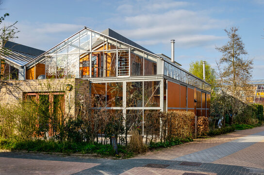 Culemborg, The Netherlands, April 8, 2023: street in Lanxmeer neighbourhood with ecological houses  with facades mainly constructed with wood and glass