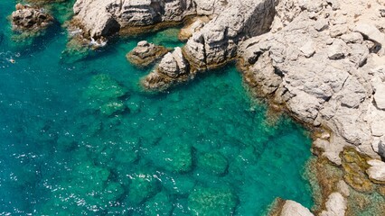 Aerial view of a rocky bay on a sunny day