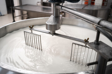 Tank full of milk in a cheese factory. Parmesan cheese production in Italy. The concept of modern...