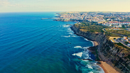 Panorama of the city from a drone with a  rocky ocean coastline during sunrise. Scenic summer ...