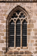 Pointed gothic window arch with trefoil tracery at St Martini church in the old town of Halberstadt, Sachsen-Anhalt region in Germany