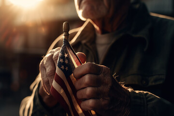 Closeup of veteran old man hand with American national flag sunlight,  heroe, Memorial Day, Independence day, AI Generative. - obrazy, fototapety, plakaty