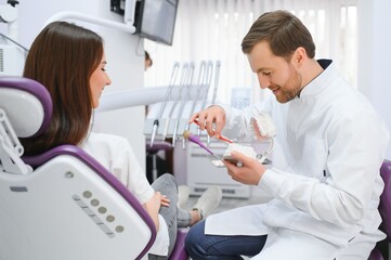 Young smiling woman with beautifiul teeth, having a dental inspection