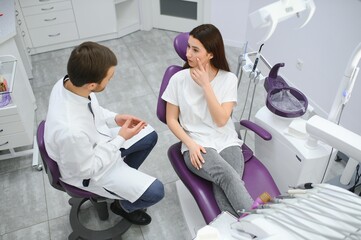 Young smiling woman with beautifiul teeth, having a dental inspection