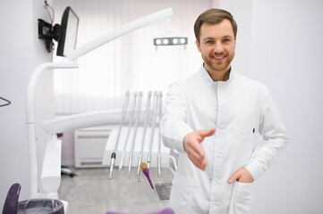 Naklejka na ściany i meble Young male dentist in clinic